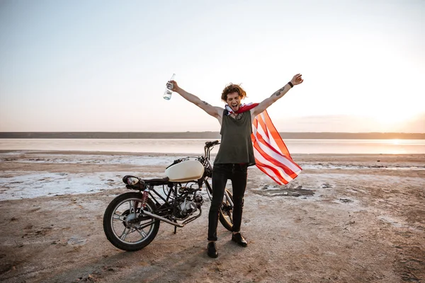 Uomo in mantello bandiera americana con le mani in alto in aria — Foto Stock