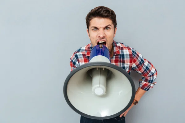 Portrait of a man screaming in megaphone — Stock Photo, Image