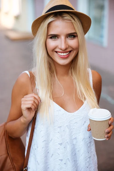 Close up of girl in hat holding take away cup — Stock Photo, Image