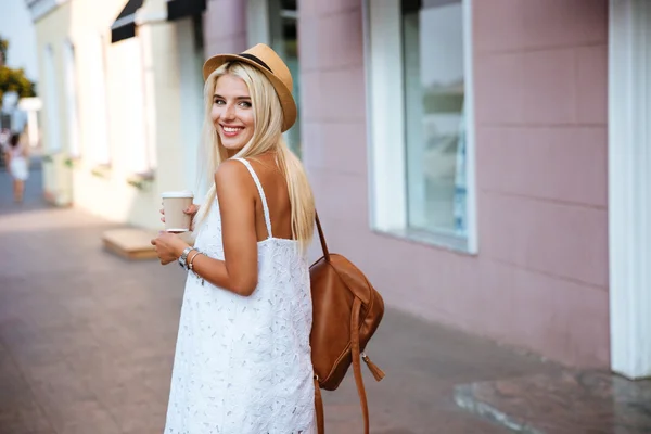 Back view of girl in dress holding take away cup — Stock Photo, Image