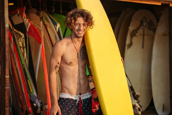 Surfboard ile genç bir sörfçü portresi