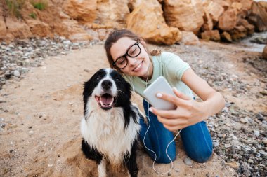 Selfie köpeği ile smartphone alarak gözlük kız