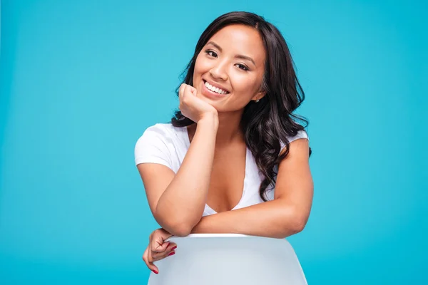 Cheerful young vietnamese woman sitting on the chair — Stock Photo, Image