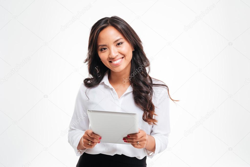 Smiling happpy asian businesswoman holding tablet computer