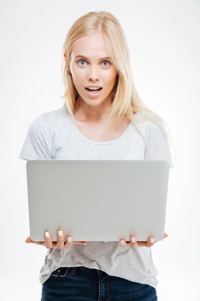 Beautiful excited woman holding laptop isolated — Stock Photo, Image