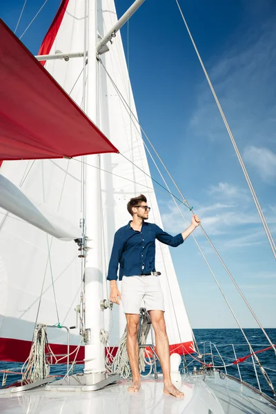 Young bearded man standing on a yacht Royalty Free Stock Photos