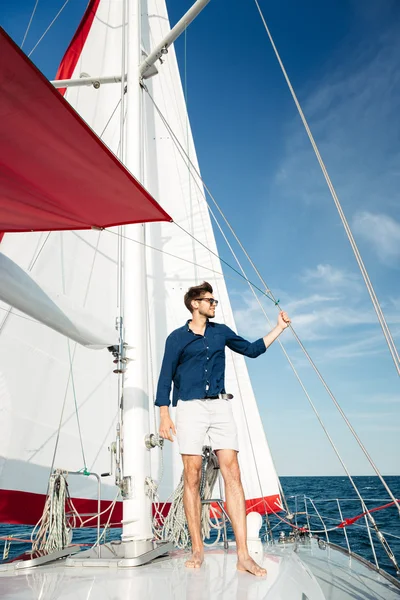 Young bearded man standing on a yacht Stock Image