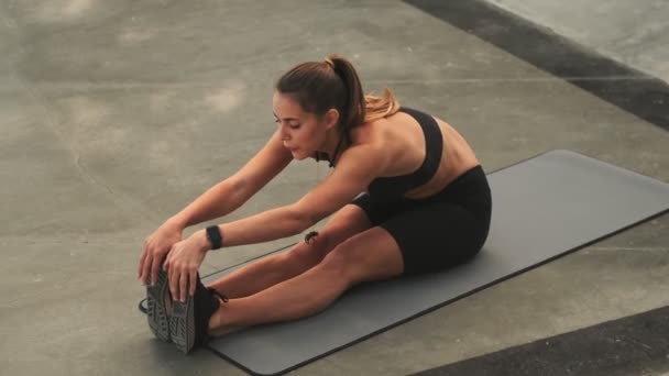 Una Joven Delgada Concentrada Está Haciendo Ejercicios Estiramiento Esterilla Yoga — Vídeos de Stock