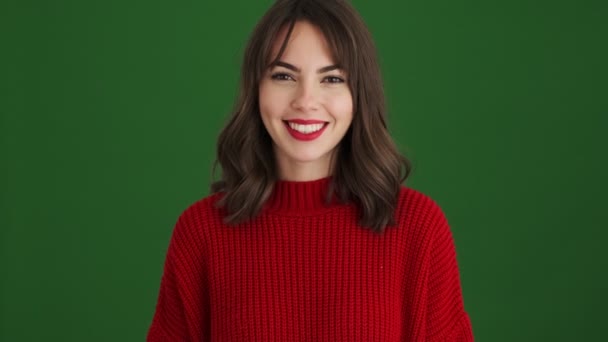 Smiling Woman Red Sweater Waving Her Hand Doing Hello Gesture — Stock Video