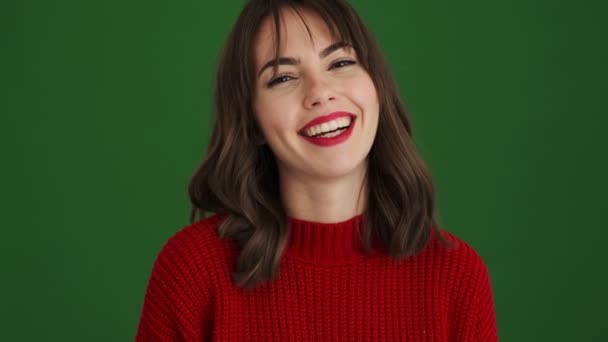 Happy Woman Red Sweater Doing Peace Gesture Standing Isolated Green — Stock Video