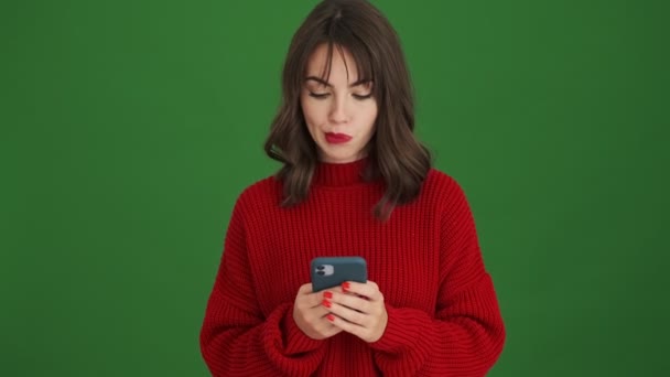 Una Joven Satisfecha Enfocada Suéter Rojo Está Utilizando Teléfono Inteligente — Vídeo de stock