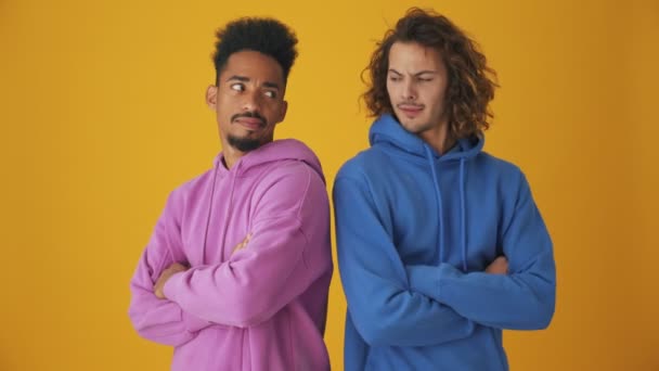 Two Displeased Guys Standing Back Back Isolated Orange Background Studio — Stock Video