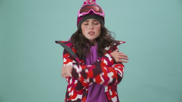 Pretty Nice Young Woman Snowboarder Feeling Cold Standing Isolated Blue — Stock Video