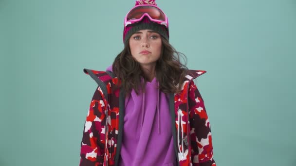 Sad Young Woman Snowboarder Standing Isolated Blue Background Studio — Stock Video