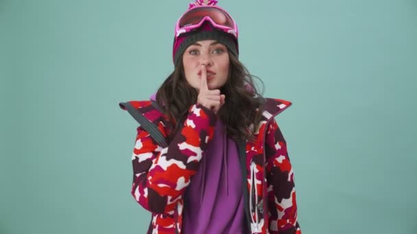 Attractive Young Woman Snowboarder Doing Secret Gesture Standing Isolated Blue — Stock Video