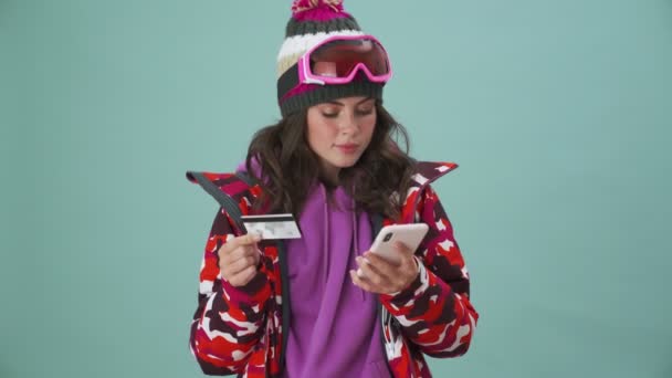 Beautiful Young Woman Snowboarder Using Her Smartphone Credit Card Standing — Stock Video