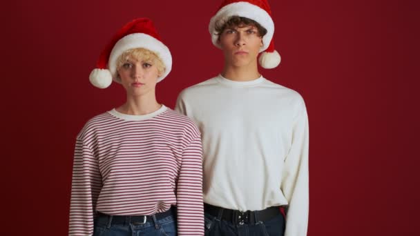 Young Serious Girl Her Brother Christmas Santa Hat Showing Gesture — Stock Video