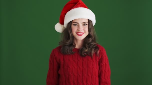 Beautiful Happy Girl Christmas Santa Hat Posing Isolated Green Wall — Stock Video