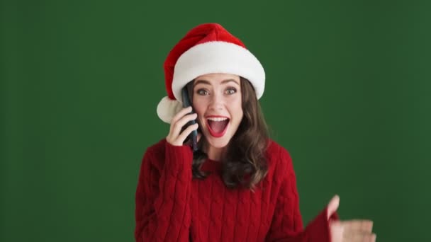 Cheerful Surprised Girl Christmas Santa Hat Talking Mobile Phone Isolated — Stock Video