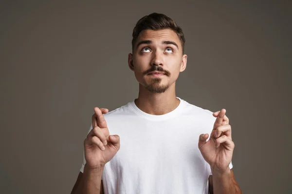 Image Thinking Unshaven Guy Posing Fingers Crossed Good Luck Isolated — ストック写真