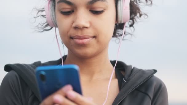 Jovem Mulher Fitness Positivo Ouvir Música Com Fones Ouvido Livre — Vídeo de Stock