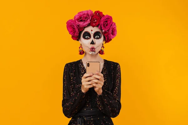 Överraskad Flicka Halloween Makeup Och Blomma Krans Med Hjälp Mobiltelefon — Stockfoto