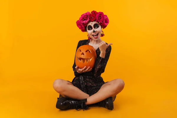 Delighted Caucasian Girl Halloween Makeup Pumpkin Pointing Finger Aside Isolated — Stock Photo, Image