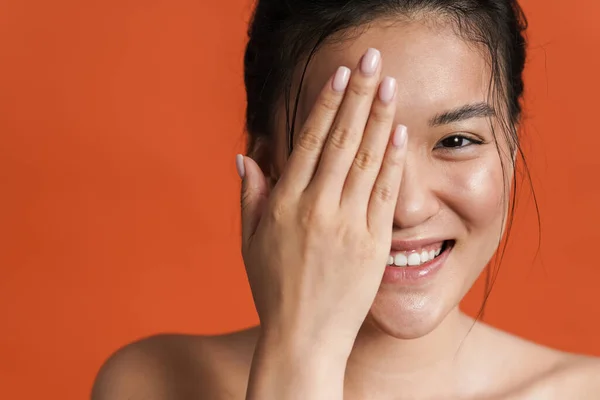 Üstsüz Asyalı Kızın Gülümseyen Gözlerini Kapatan Görüntüsü Turuncu Arka Planda — Stok fotoğraf
