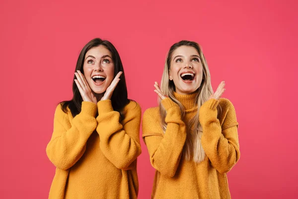 Two Happy Young Girls Looking Copy Space Isolated Pink Background — Stock Photo, Image