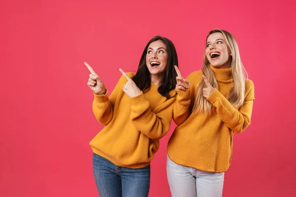 Image Excited Beautiful Women Smiling While Pointing Fingers Aside Isolated — Stock Photo, Image