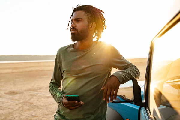 Imagem Homem Afro Americano Sério Usando Telefone Celular Enquanto Viaja — Fotografia de Stock