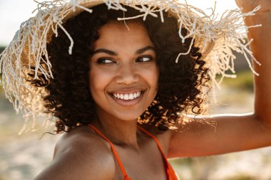 Sahilde genç, çekici, Afro-Amerikan bir kadının fotoğrafını çek.