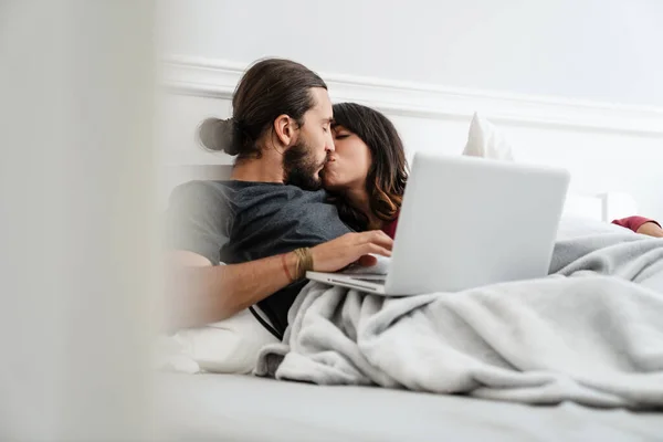 Image Romantic Happy Couple Using Laptop Kissing While Lying Bed — 图库照片
