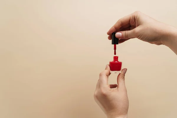 Mãos Mulher Segurando Verniz Vermelho Unha Isolado Sobre Fundo — Fotografia de Stock