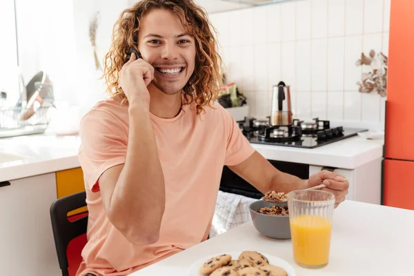 Image Cheerful Young Handsome Curly Man Indoors Home Talking Mobile — Stock Photo, Image