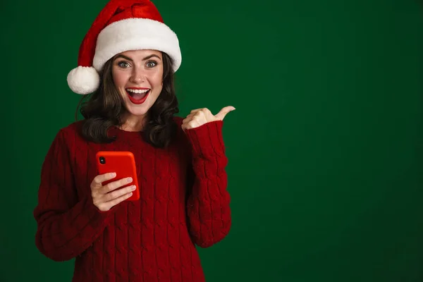 Nice Excited Girl Santa Claus Hat Using Cellphone Pointing Finger — Stock Photo, Image