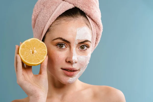 Shirtless Pleased Girl Nourishing Mask Holding Lemon Isolated Blue Background — Stock Photo, Image