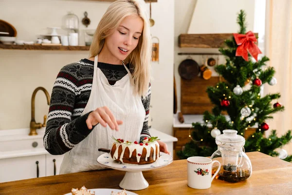 Önlüklü Hoş Bir Kız Noel Pastası Tadıyor Evde Çay Içiyor — Stok fotoğraf