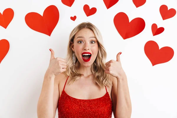 Photo Young Surprised Blonde Woman Red Dress Showing Thumbs Gesture — Stock Photo, Image