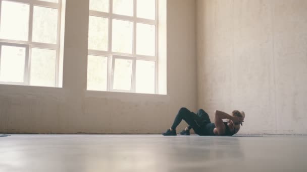 ブロンド男あります練習横に床とポンプ彼のプレスでザグレースタジオ — ストック動画