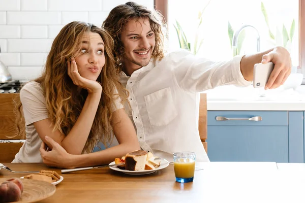 Joyful Beautiful Couple Taking Selfie Cellphone While Having Breakfast Cozy Royalty Free Stock Photos