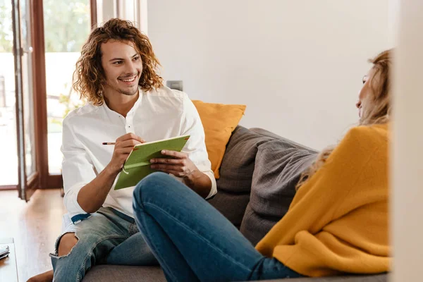 Happy Handsome Guy Drawing Portrait His Girlfriend While Sitting Couch — ストック写真