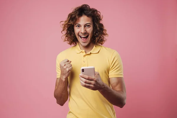 Portrait Excited Young Man Using Mobile Phone Isolated Pink Background — 图库照片