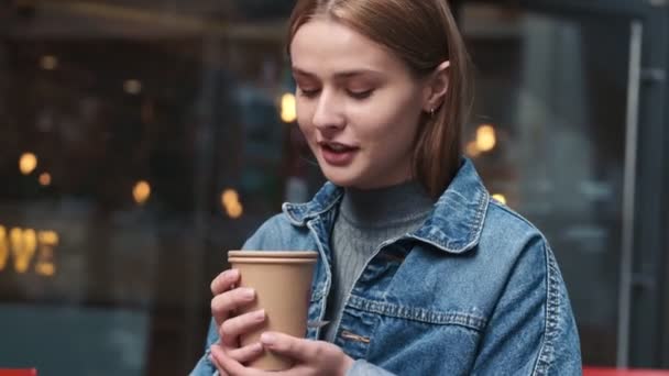 Eine Zufriedene Junge Frau Hält Stadtcafé Ein Heißgetränk Einem Bastelpapierbecher — Stockvideo