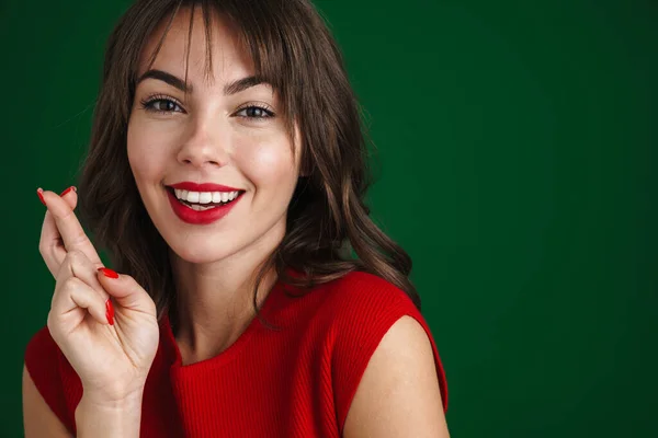 Portrait Worried Woman Wearing Red Dress Isolated Green Background Holding — Φωτογραφία Αρχείου