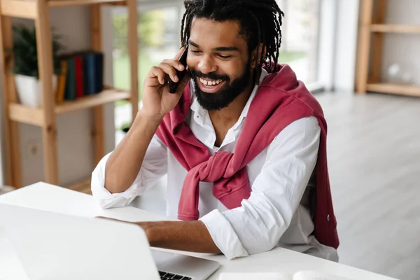Šťastný Africký Američan Mluví Mobilu Pracuje Notebookem Kanceláři — Stock fotografie