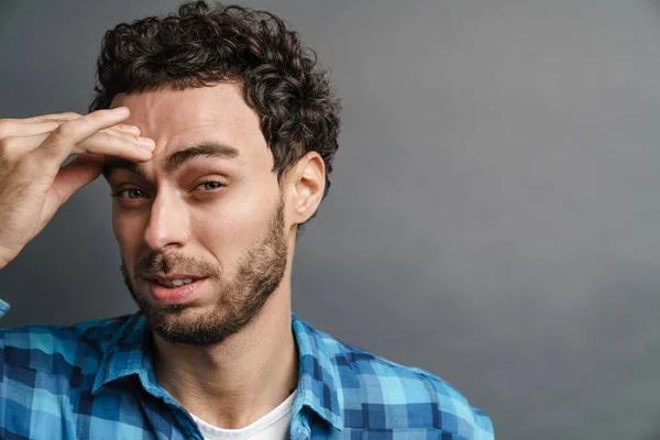 Ongeschoren Knappe Jongen Met Hoofdpijn Poseren Camera Geïsoleerd Grijze Achtergrond — Stockfoto