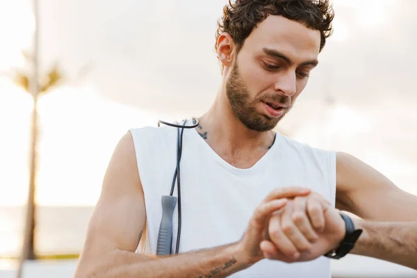 Focused Unshaven Guy Looking Wristwatch While Working Out Jump Rope — Stock Photo, Image