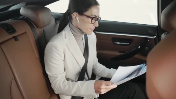 Pleased Young Businesswoman Wearing Glasses Talking Phone Holding Paper Documents — Stock Video