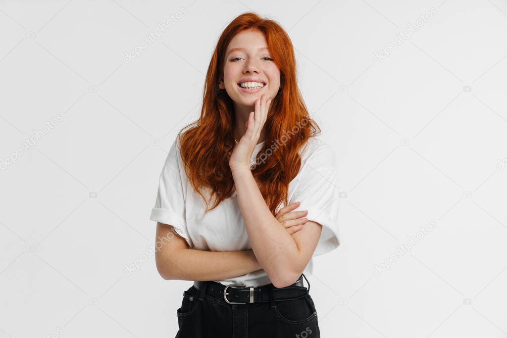 Ginger beautiful happy girl posing and smiling at camera isolated over white background